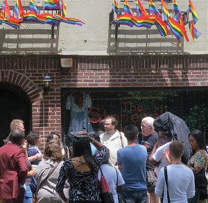 DIRECT EXPERIENCE OF AMERICA: Outside the Stonewall Inn, LGTB tour guide Laurence  Frommer (facing the camera, left) and the State Department’s Tom Gallagher fielded questions from LGBTI activists brought here for the International Visitor Leadership Programs.  Photo by Maggie Berkvist.